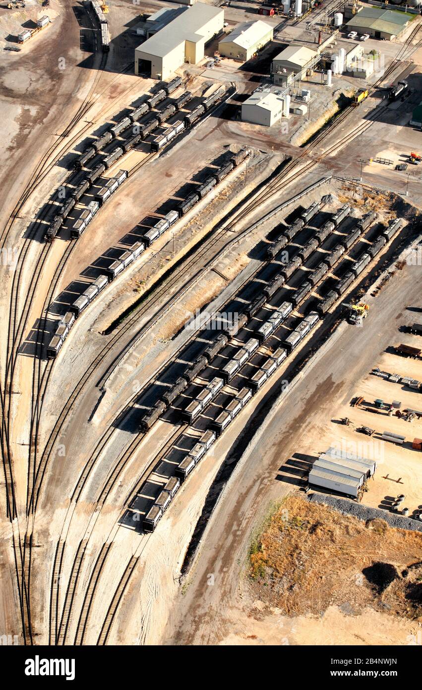 Parallel rows of railroad tanker and hopper cars waiting on a siding after being filled with ore from a mine. Stock Photo