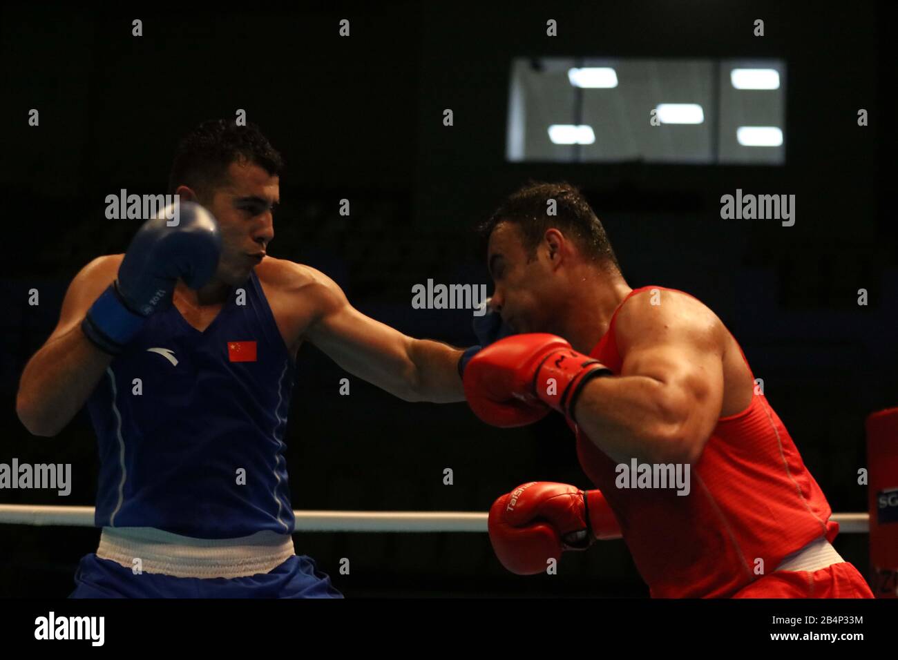 Amman, Jordan. 6th Mar, 2020. Maimaiti Aihemaiti (L) of China competes with  Iman Ramezanpoudelavari of Iran during their men's Super-Heavyweight (  91kg) Preliminaries bout at the Asian/Oceanian Boxing Qualification  Tournament for 2020