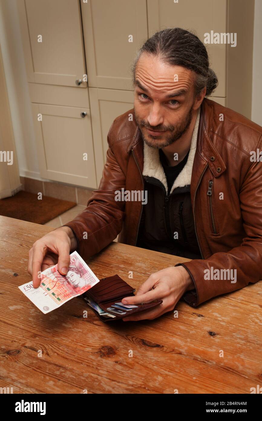 A man offering 50 pounds in cash Stock Photo