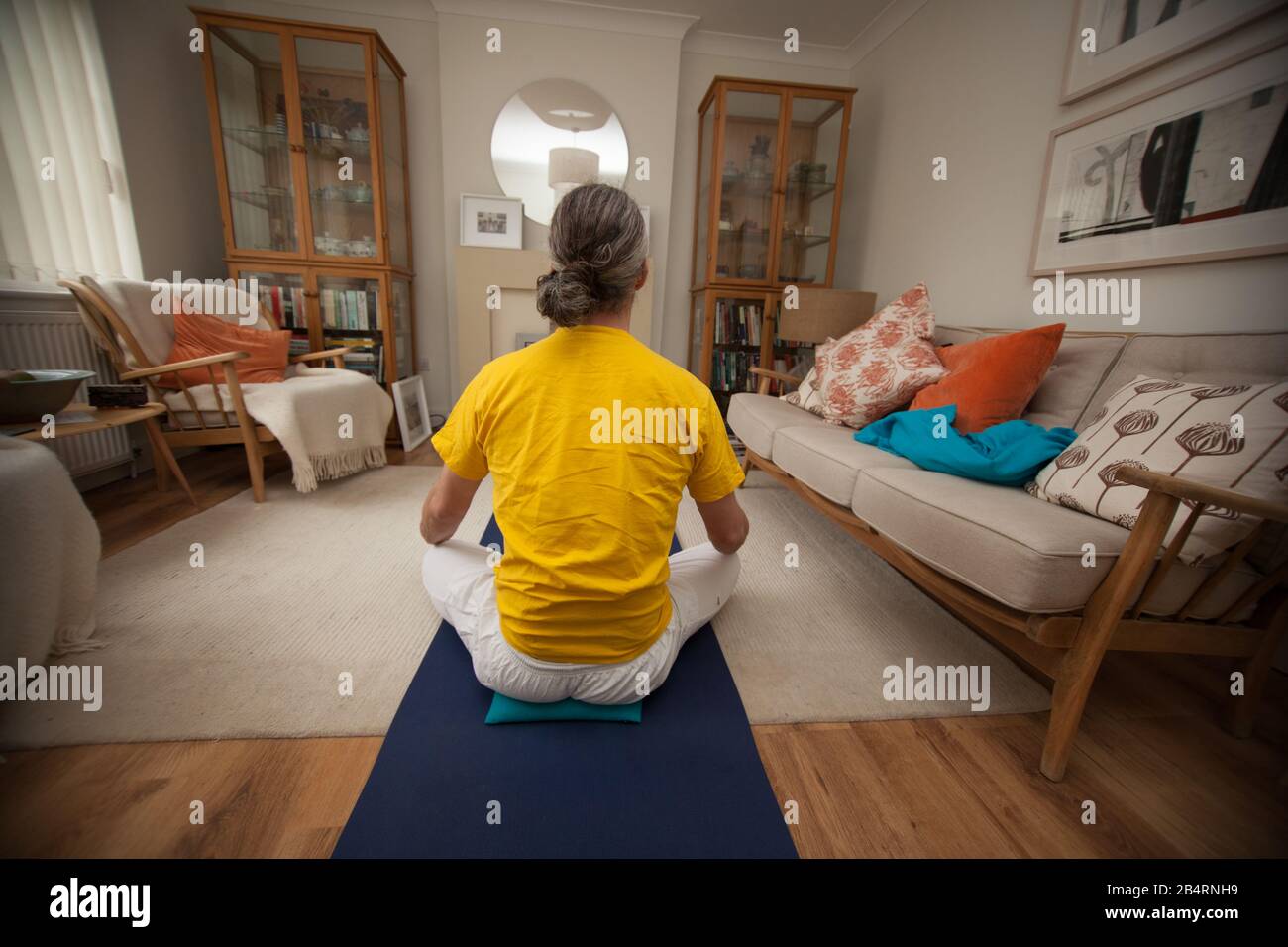 A man meditating as part of his Yoga routine Stock Photo