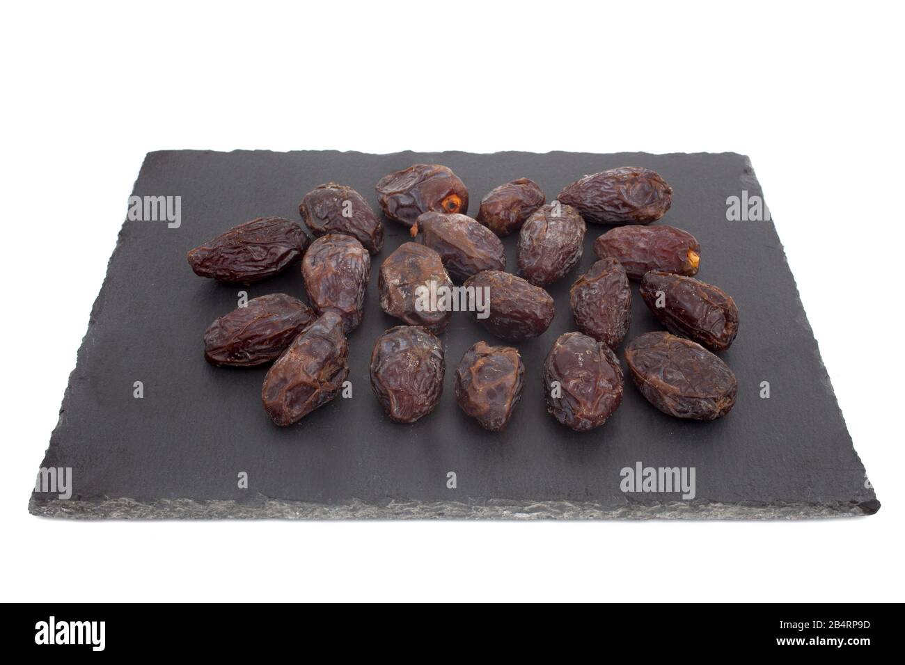 A studio photograph of dates against a slate background Stock Photo
