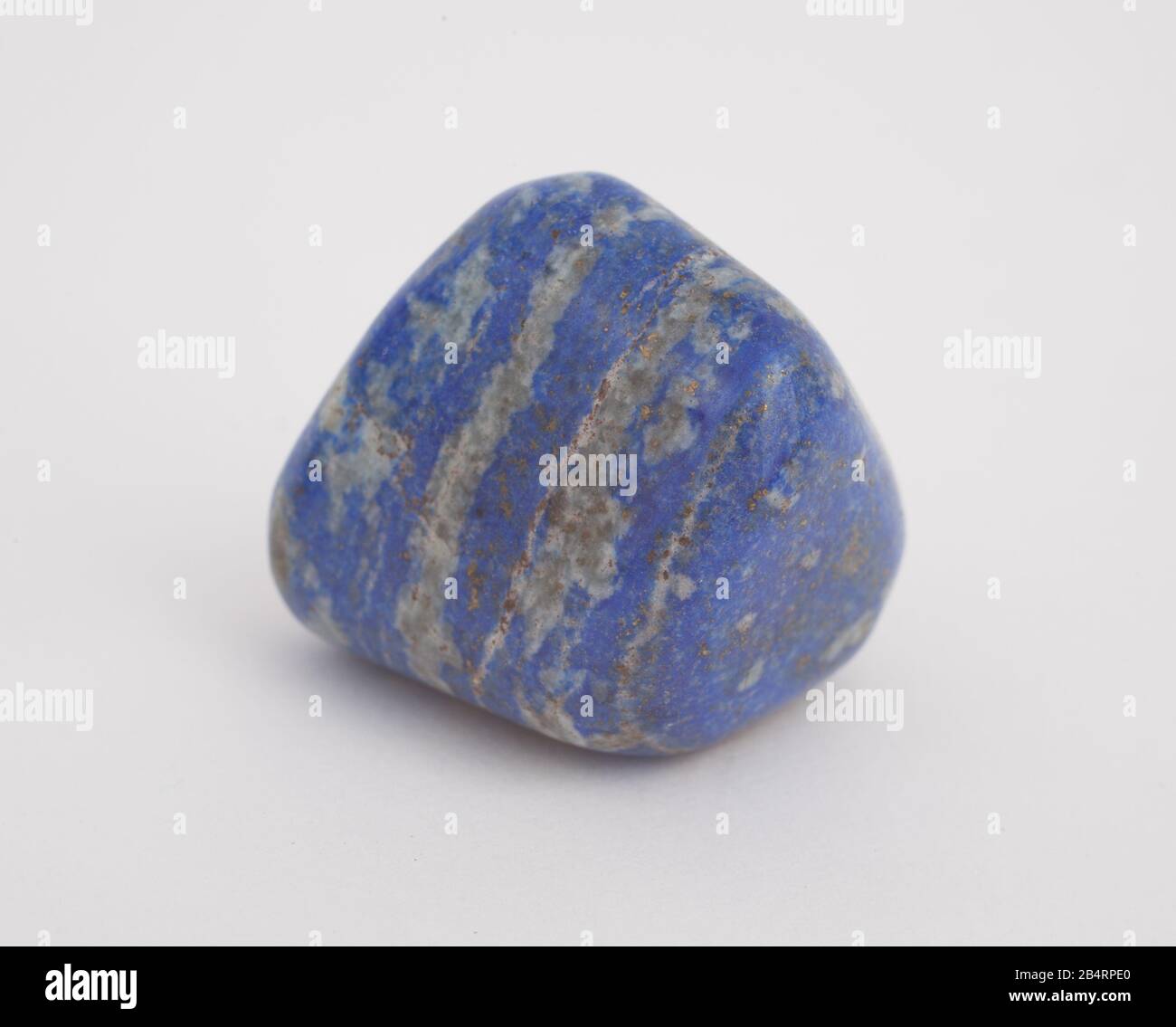 A blue grey gemstone photographed against a white background Stock Photo