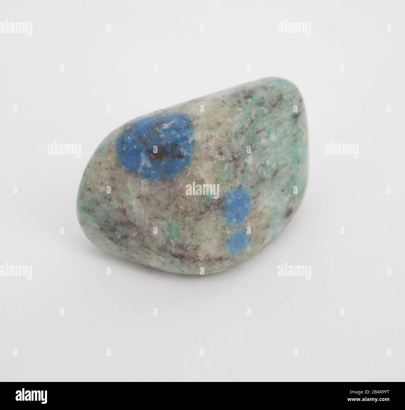 A blue grey gemstone photographed against a white background Stock Photo