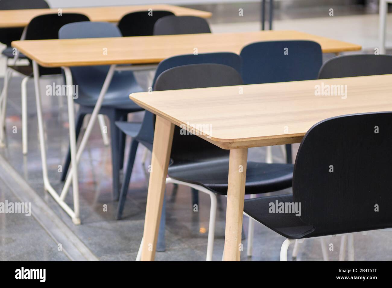 Modern tables and black chairs in shopping malls. Close up. Stock Photo