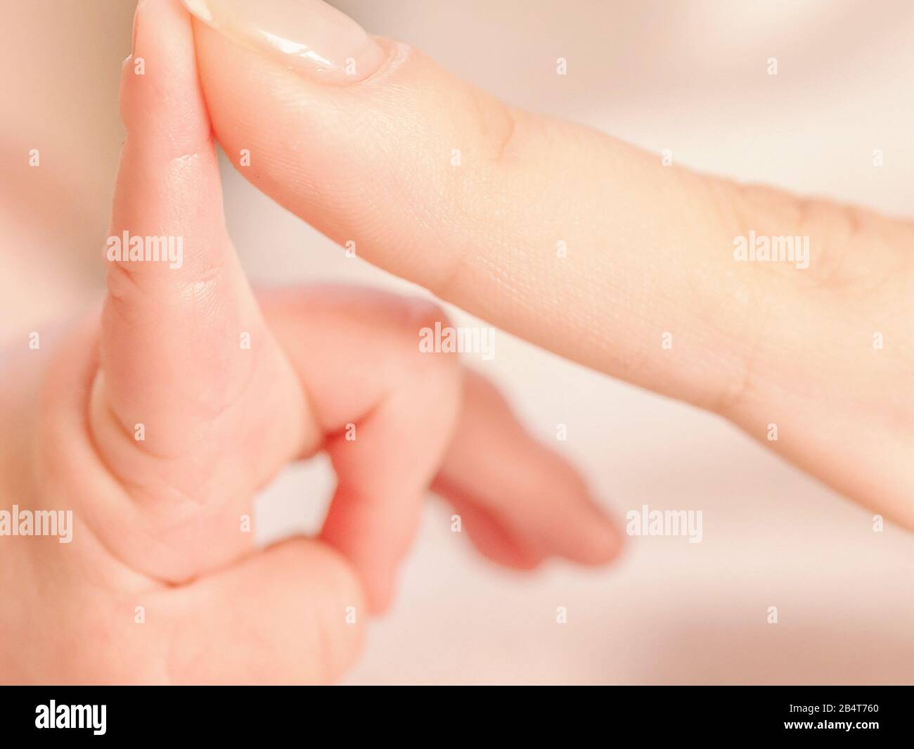 Close up of a Mother holding newborn babys hand Stock Photo