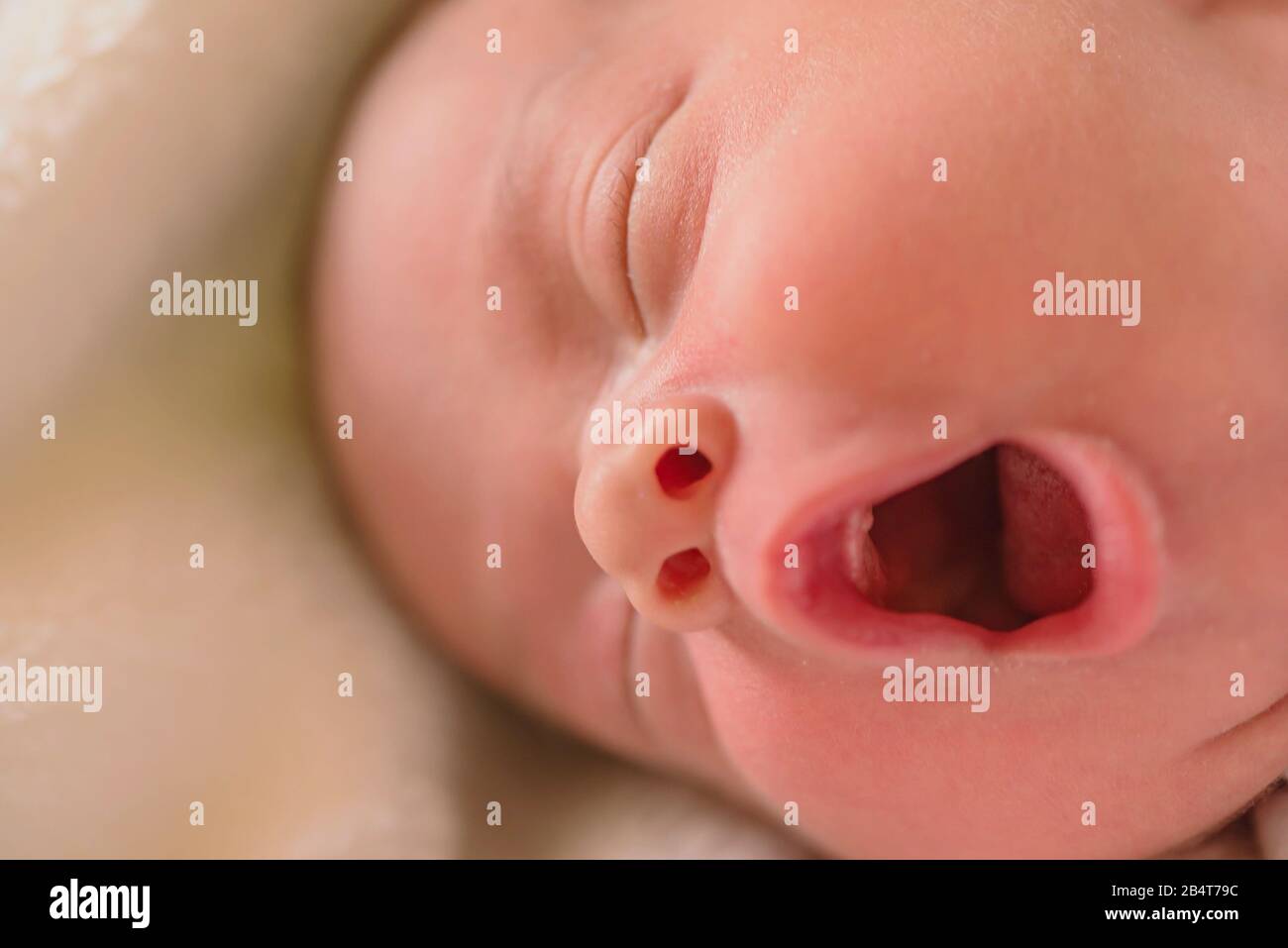 Portrait of a newborn sleepy  baby boy yawning Stock Photo