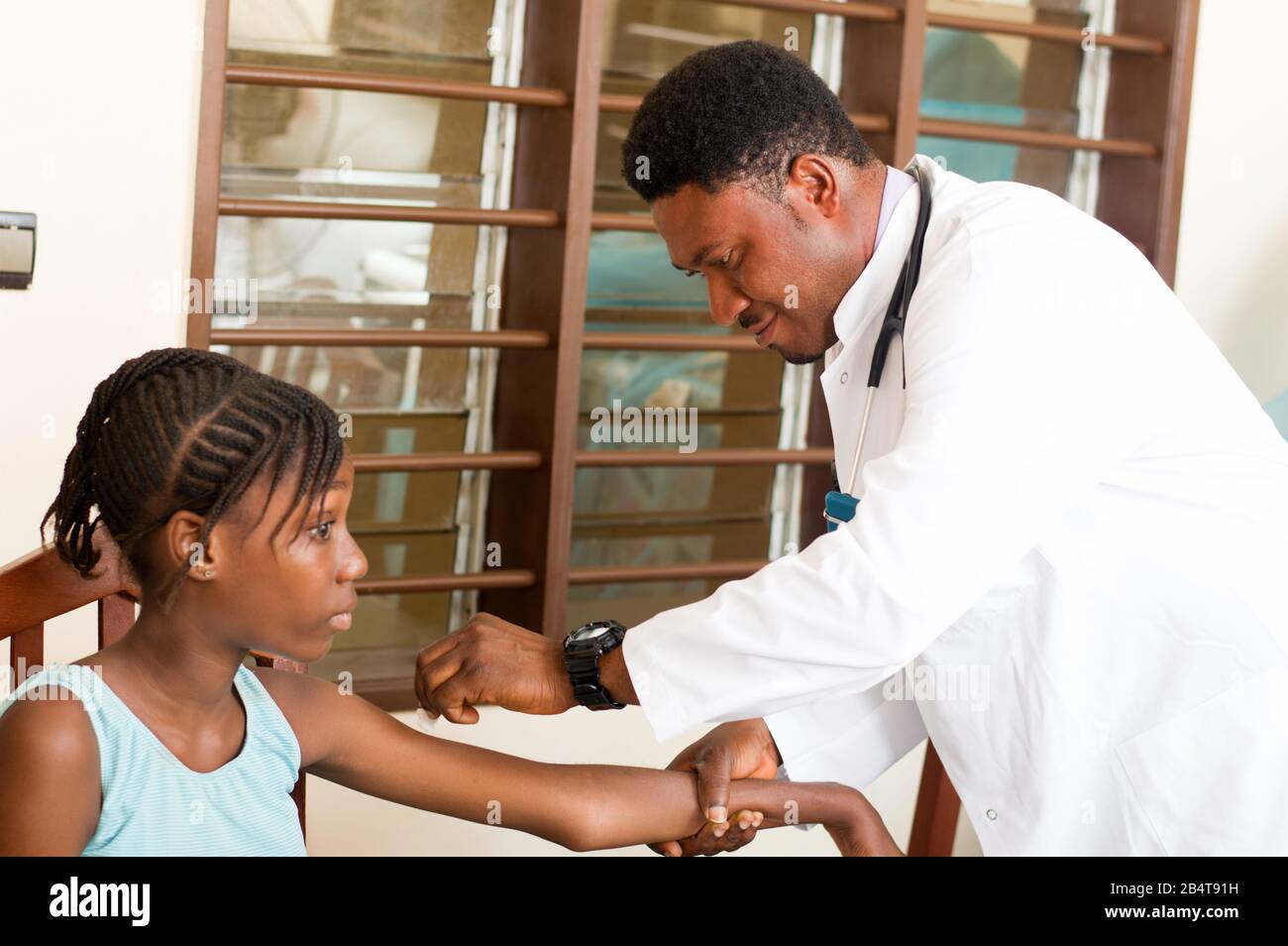 doctor makes an injection to a patient in his office at the hospital ...
