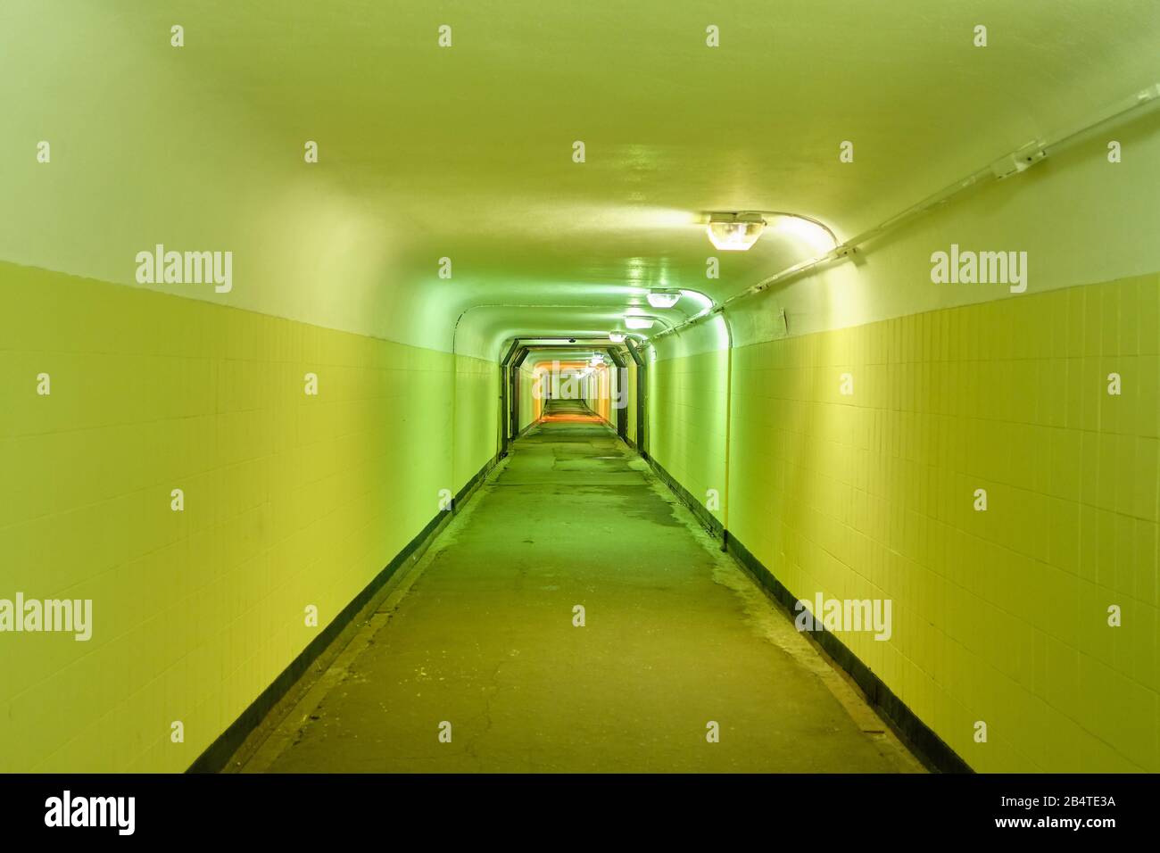 Underground pedestrian tunnel with green walls. Close up. Stock Photo