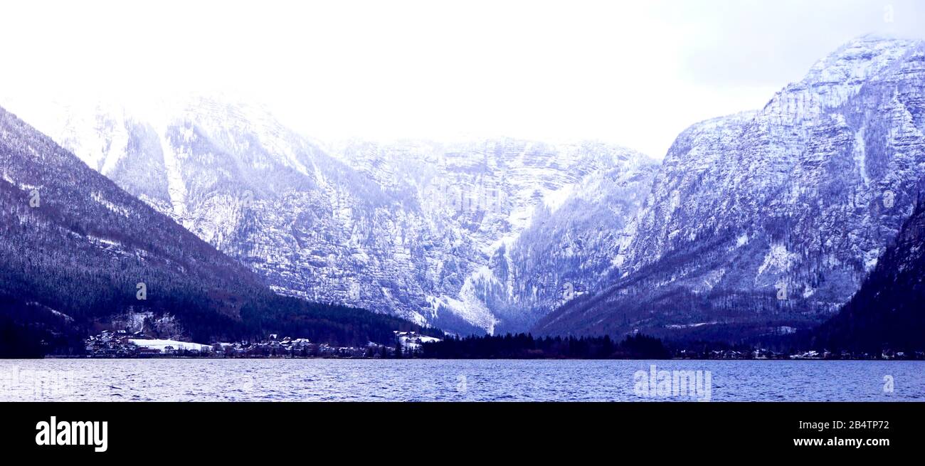 Panorama of Hallstatt lake outdoor with snow mountain background blue tone in Austria in Austrian alps Stock Photo