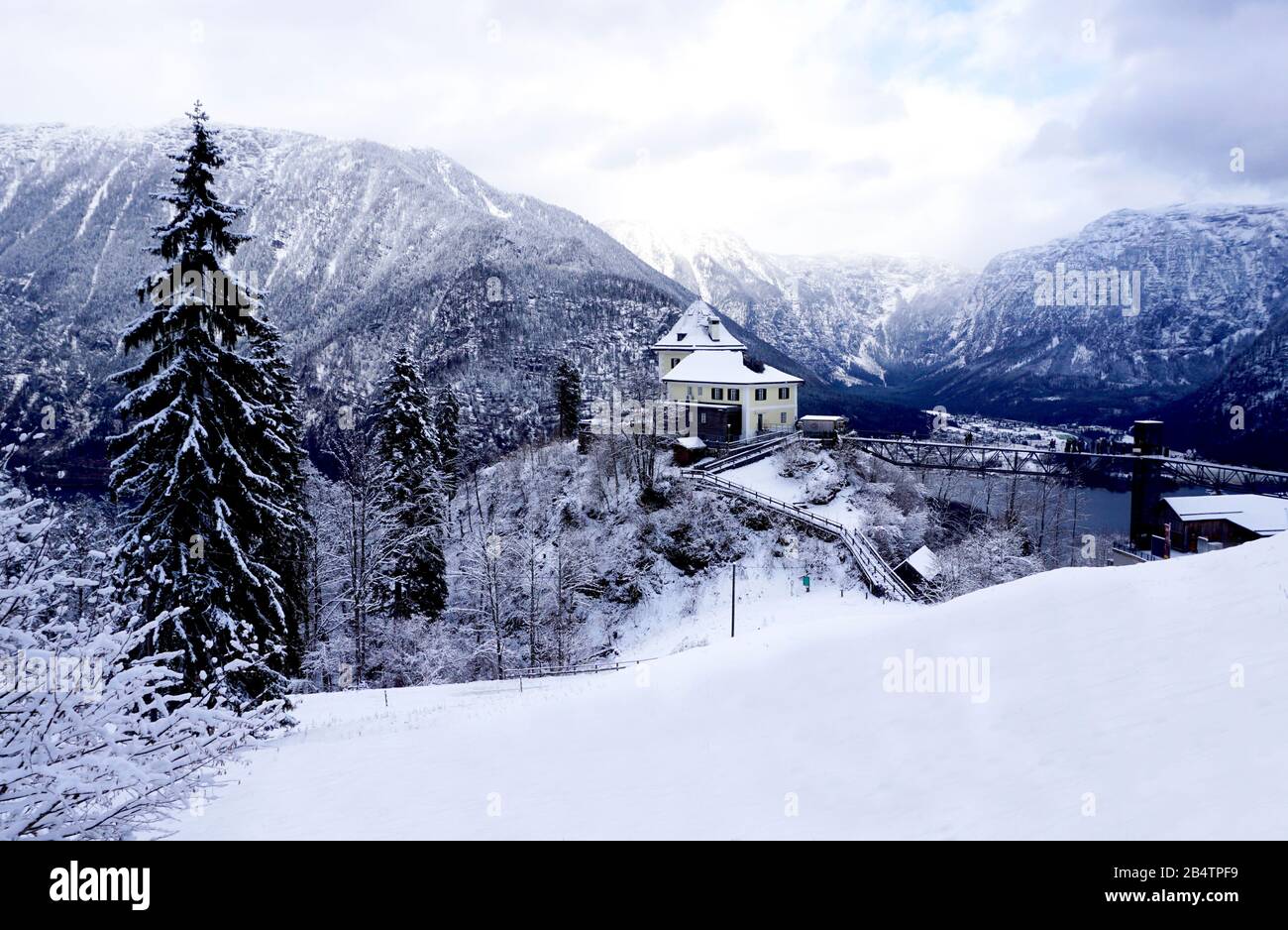 Viewpoint of Hallstatt Winter snow mountain landscape hike epic mountains outdoor adventure and lake through the forest in upland valley leads to the Stock Photo