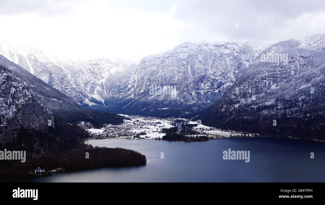 Viewpoint of Hallstatt Winter snow mountain landscape hike epic mountains outdoor adventure and lake through the forest in upland valley leads to the Stock Photo