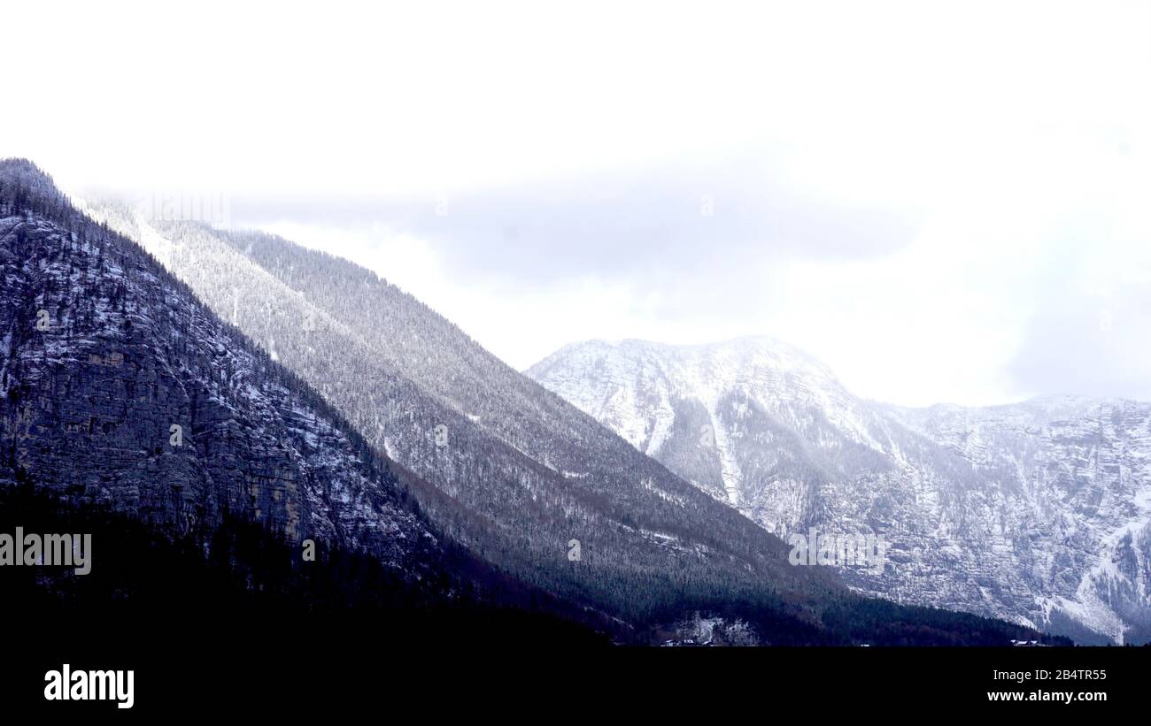 Winter snow peak mountain landscape hike epic mountains outdoor adventure the pine forest in upland valley leads to salt mine Hallstatt, Austria Stock Photo