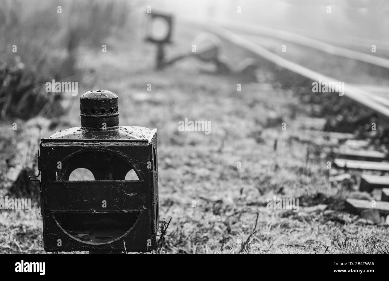 Old railroad derailer lantern at railway junction - monochrome image Stock Photo