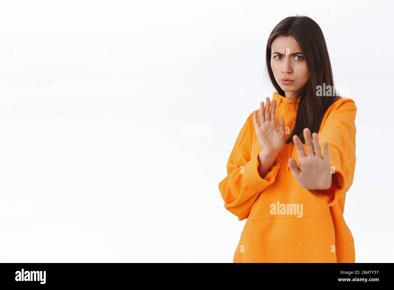 Ugh, yuck. Disgusted and reluctant feminine young woman saying please stop frowning and grimacing from disapproval and aversion, dont like offer, step Stock Photo