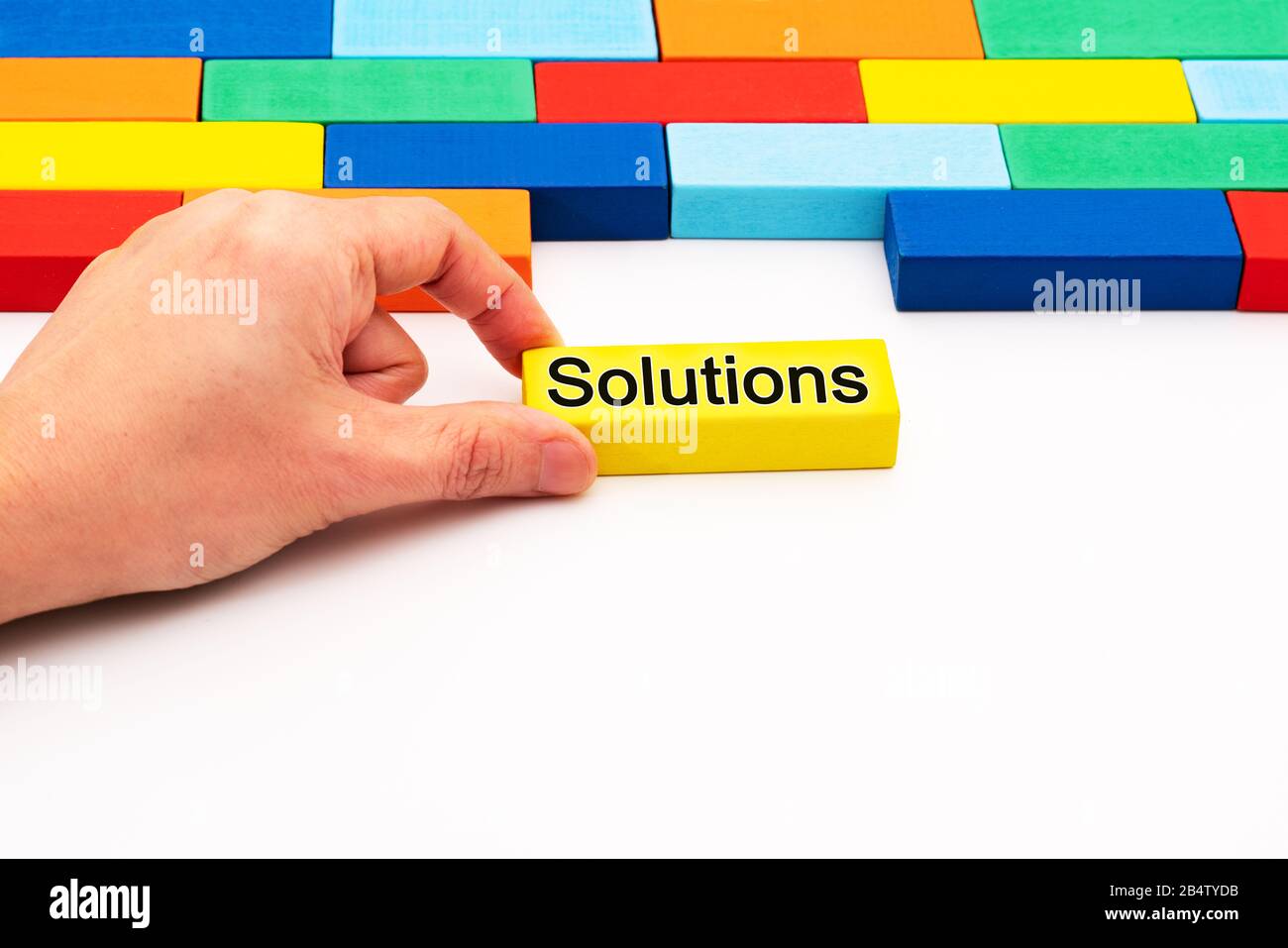 fill in business solutions concept, a piece of wooden block puzzle fit in a blank space Stock Photo