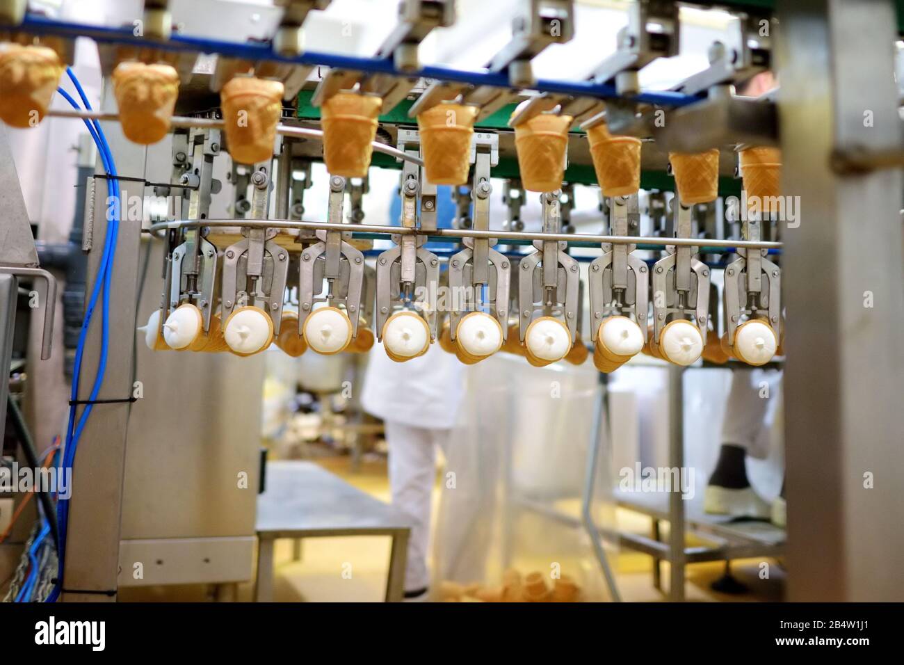 Closeup shot of moving conveyer with icecream cones ready for packing