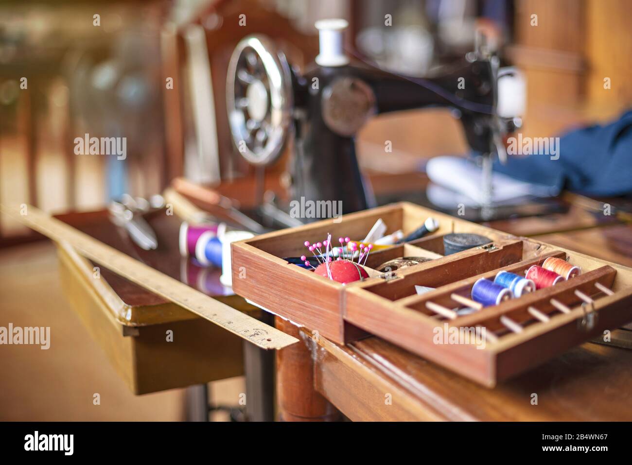 sewing tools and reels of color thread on table. Handmade clothes dressmaking and sewing Concept Stock Photo