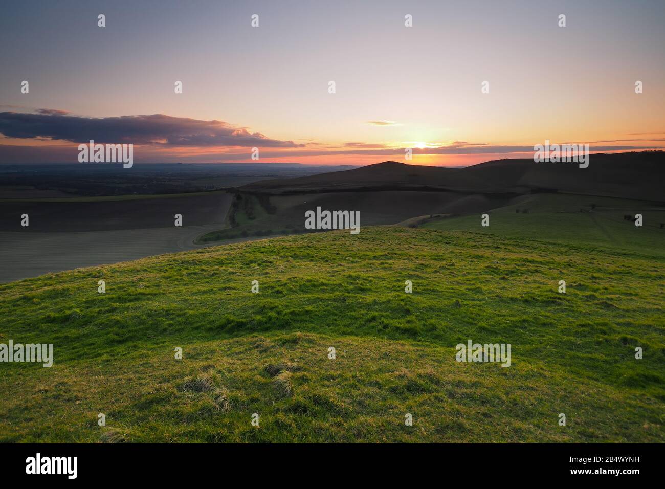 Sunset from the top of Knap Hill looking across the Vale of Pewsey, North Wessex Downs, Wiltshire Stock Photo