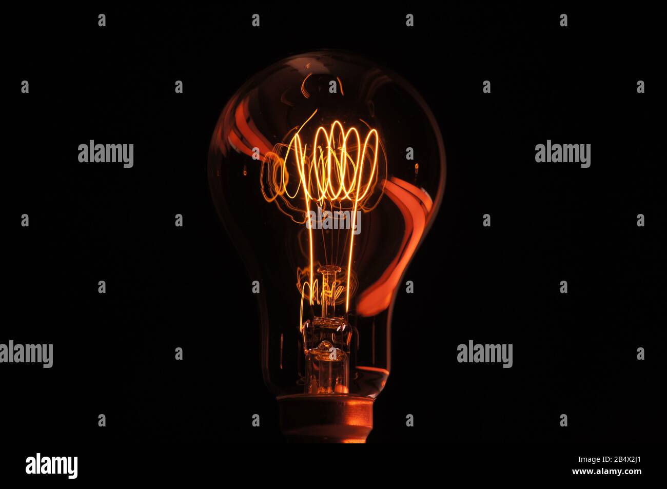 Carbon filament incandescent lamp accented by colour from fluorescent