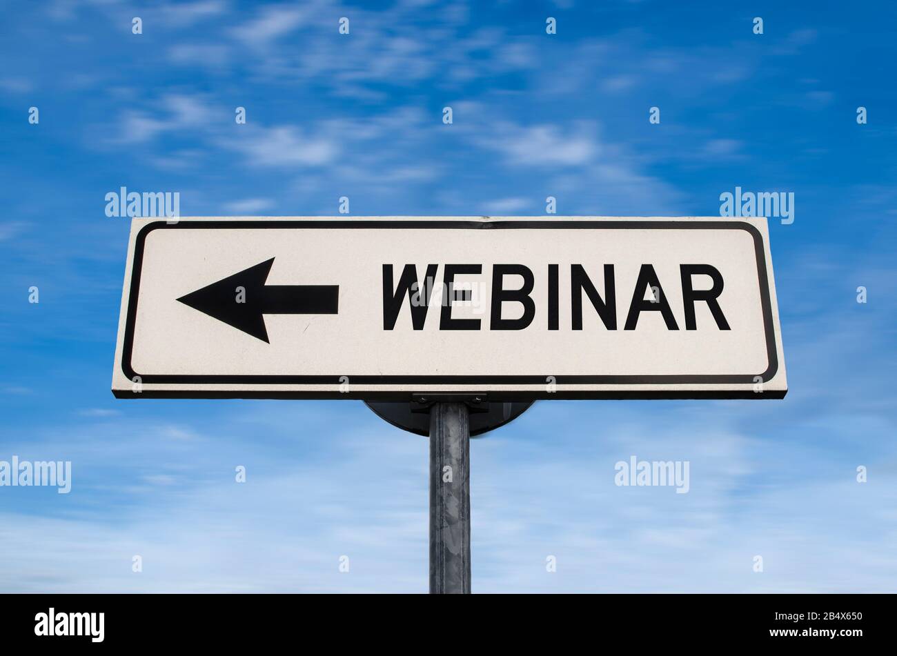 Webinar road sign, arrow on blue sky background. One way blank road sign with copy space. Arrow on a pole pointing in one direction. Stock Photo