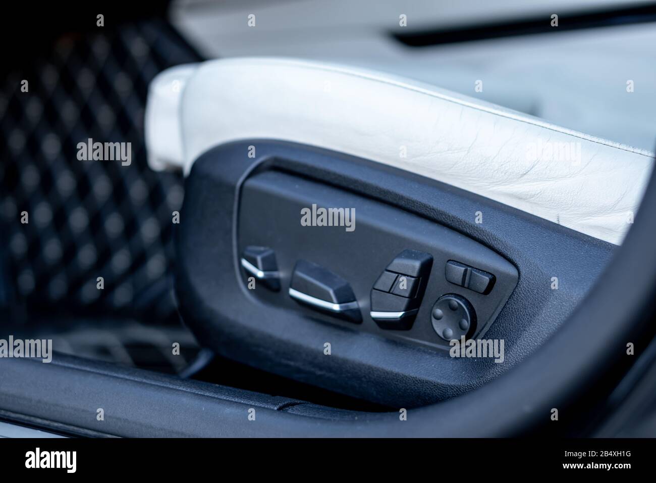 Beautiful german car luxurious interior with white leather, black trim ornaments, heated and ventilated seats, harman kardon sound system, individual Stock Photo