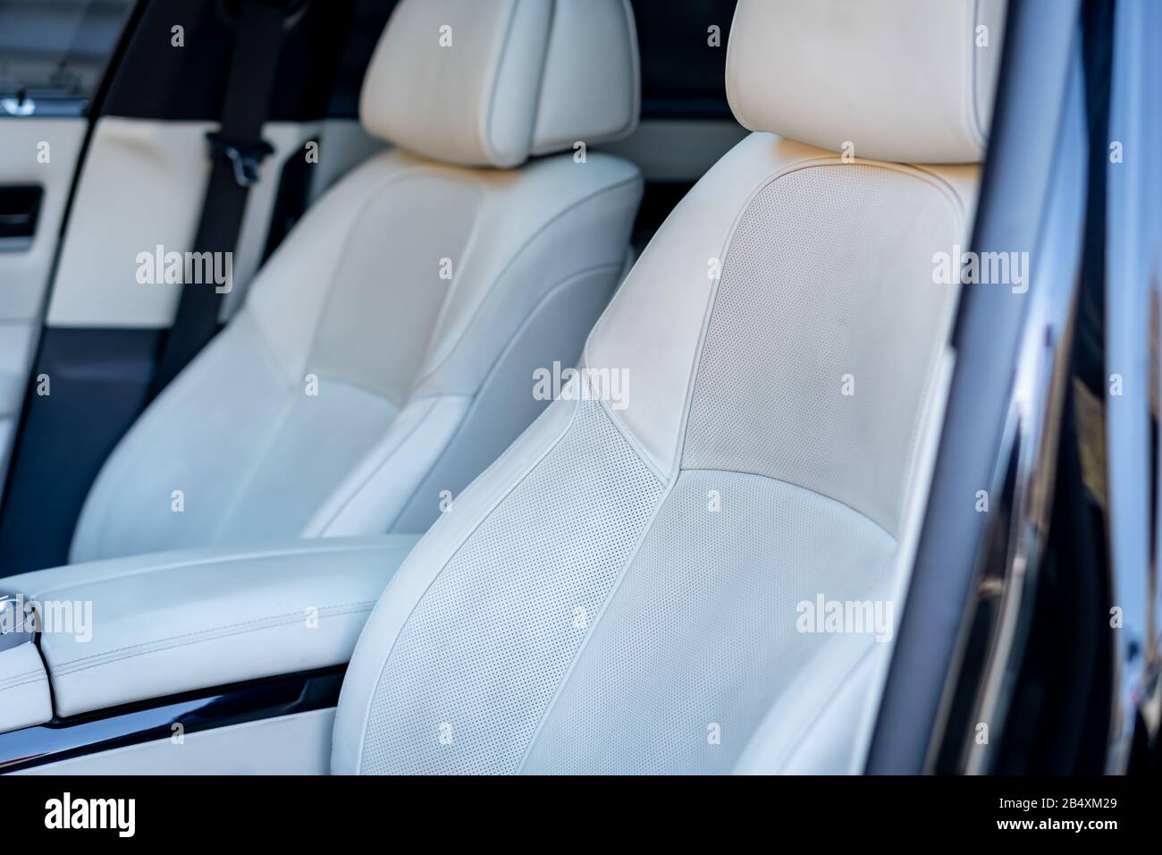 Beautiful german car luxurious interior with white leather, black trim ornaments, heated and ventilated seats, harman kardon sound system, individual Stock Photo