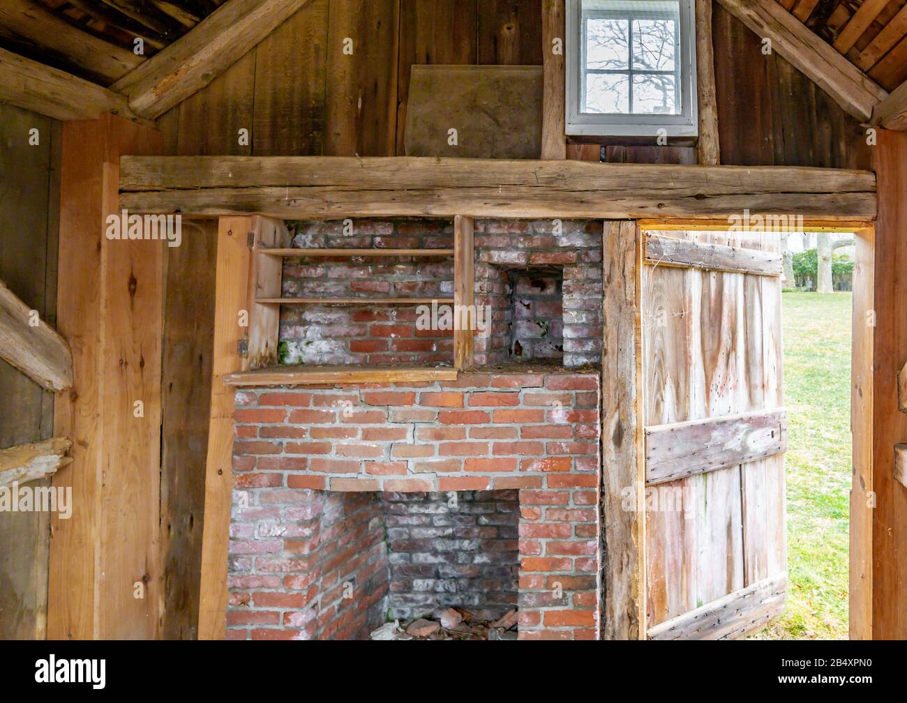 Interior image of an small one room house with a brick fireplace Stock Photo