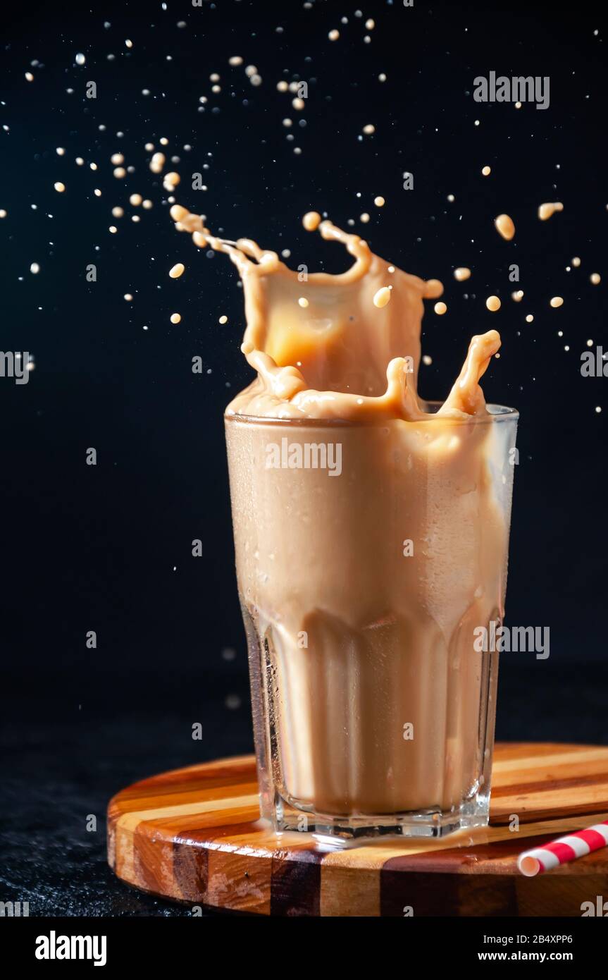 Iced coffee in tall glass. One sweet cold latte with whipped cream, with  chemex coffee maker on dark brown background copy space Stock Photo - Alamy