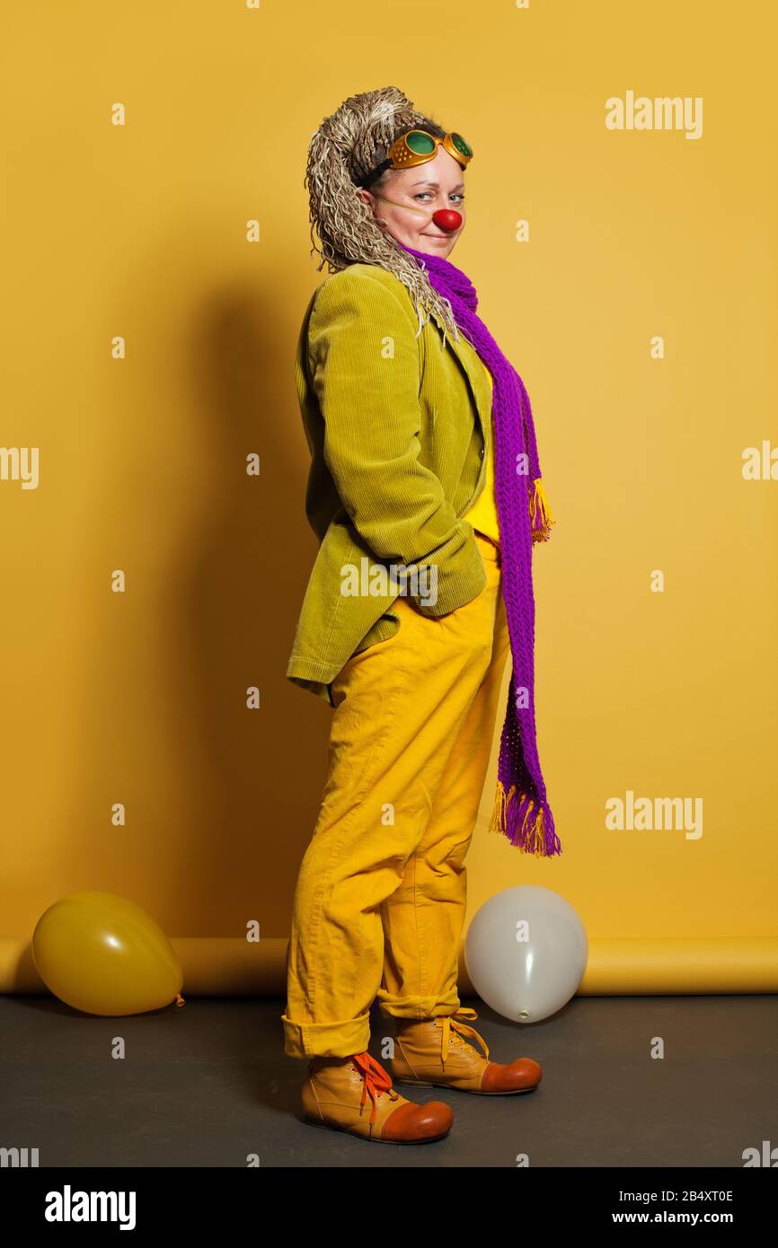 Woman clown on yellow background Stock Photo - Alamy