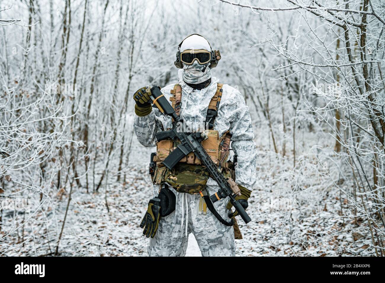 Military man in white camouflage uniform with machinegun. Soldier in the  winter forest territory background. Horizontal photo Stock Photo - Alamy