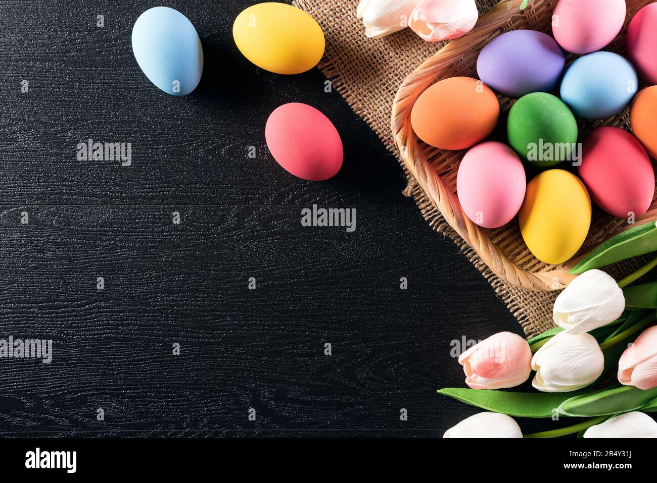 Happy easter! Colorful of Easter eggs in nest with tulips flower and ...