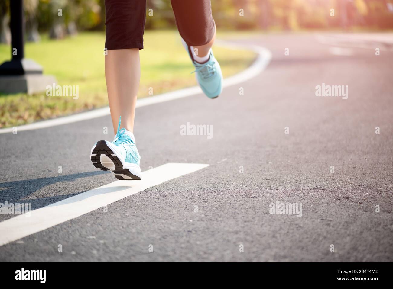 Closeup woman running towards on the road side. Step, run and outdoor ...