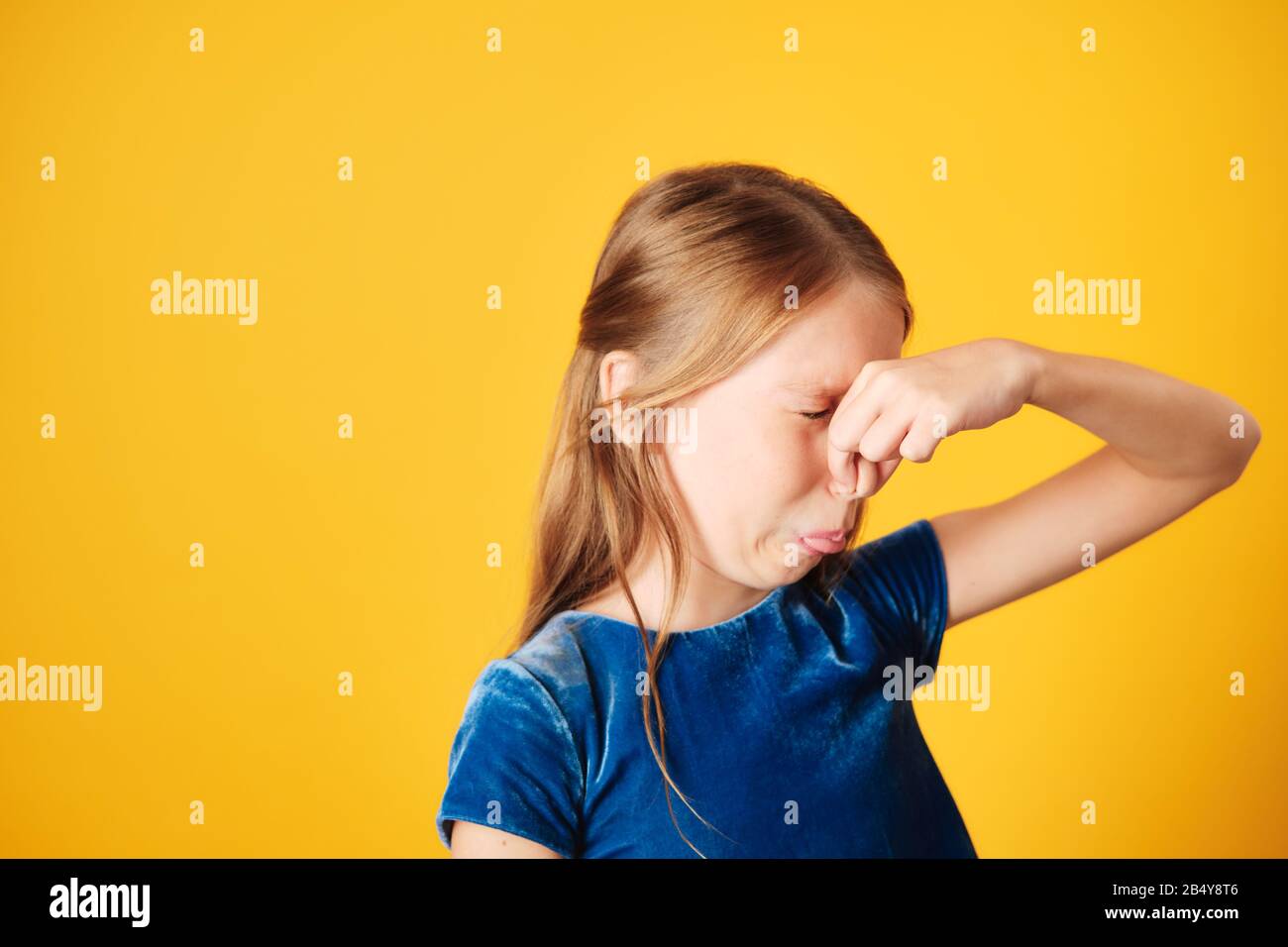 Little Redhead Girl Covering Nose For Bad Smell Stock Photo