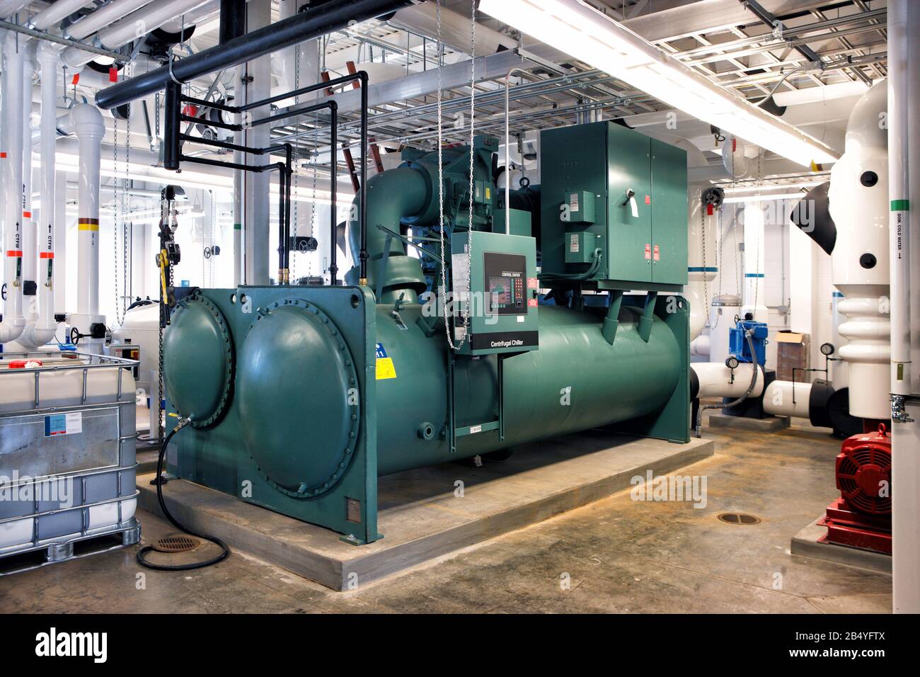 A large industrial condenser unit for a chiller in an HVAC system. Stock Photo