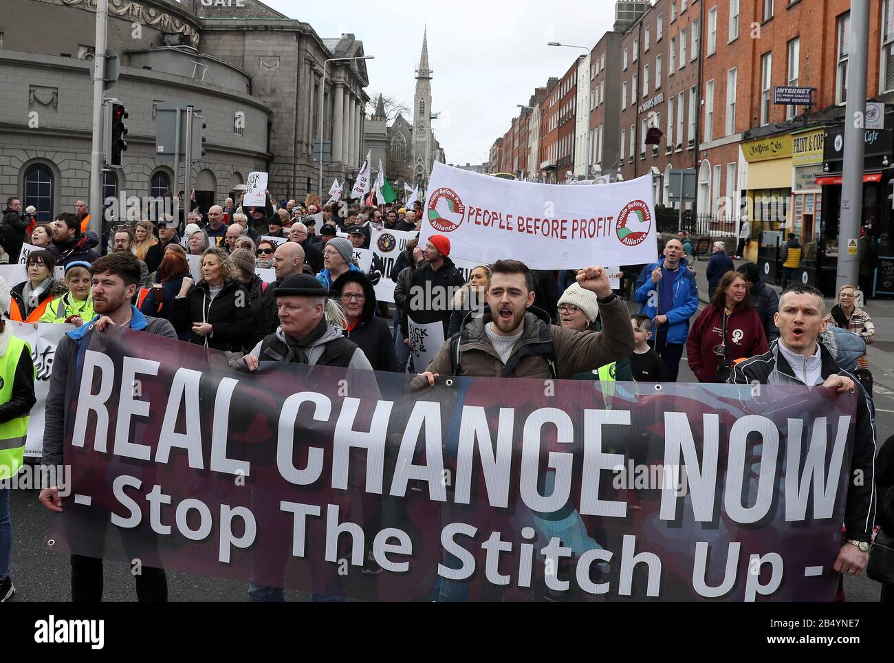 People take part in a march in Dublin's city centre organized to demonstrate opposition to the formation of a new government involving Fianna Fail or Fine Gael. Stock Photo