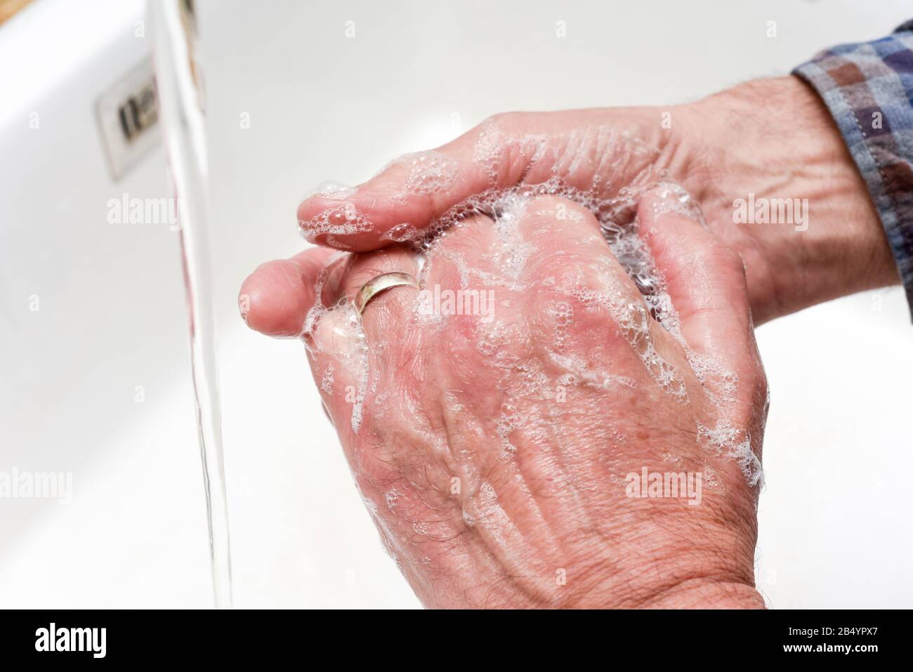 Person washing hands with water and soap in a sink Stock Photo - Alamy