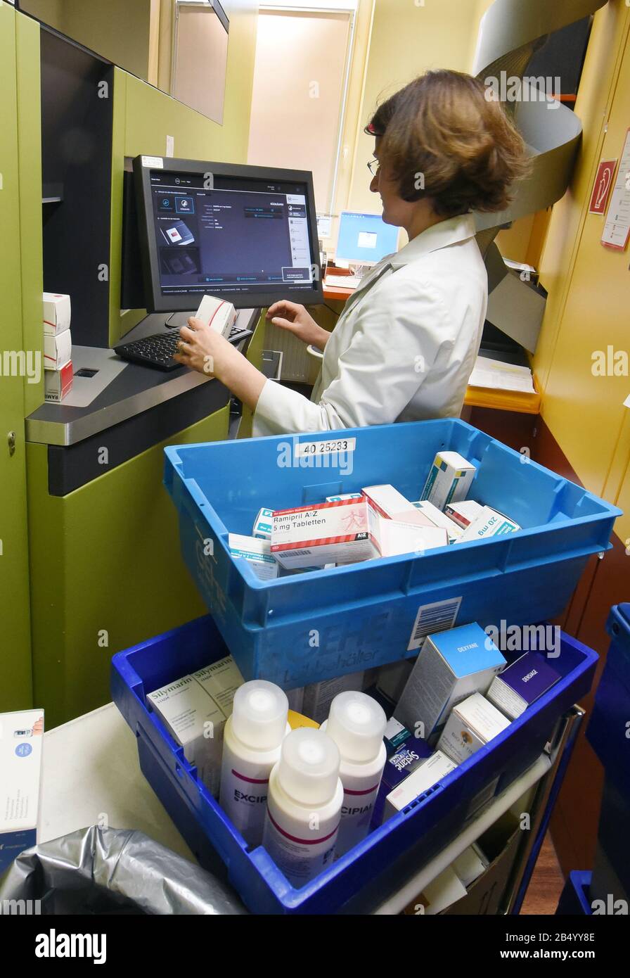 Leipzig, Germany. 06th Mar, 2020. A pharmacist in the rose pharmacy in the  Auwald forest uses a computer to fill the medicine store where a robot is  working. When requested by a