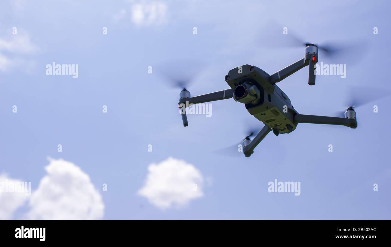 Quadcopter drone in flight with camera. Stock Photo