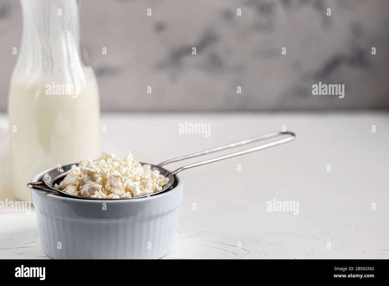 Fresh cottage cheese in a transparent bowl with raisins. In the