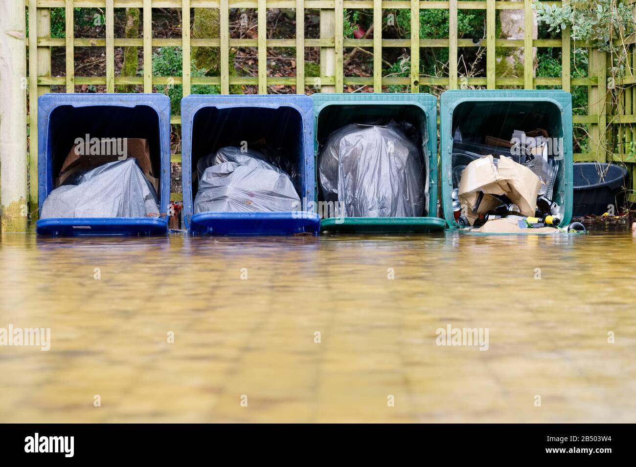 Fallen wheelie bins black bin bag rubbish on side over ground Stock Photo Alamy