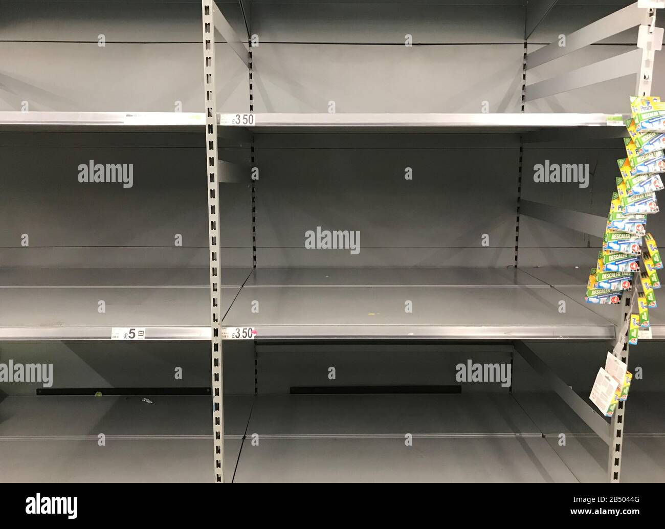 Empty shelves where toilet roll is usually stocked in an Asda store in