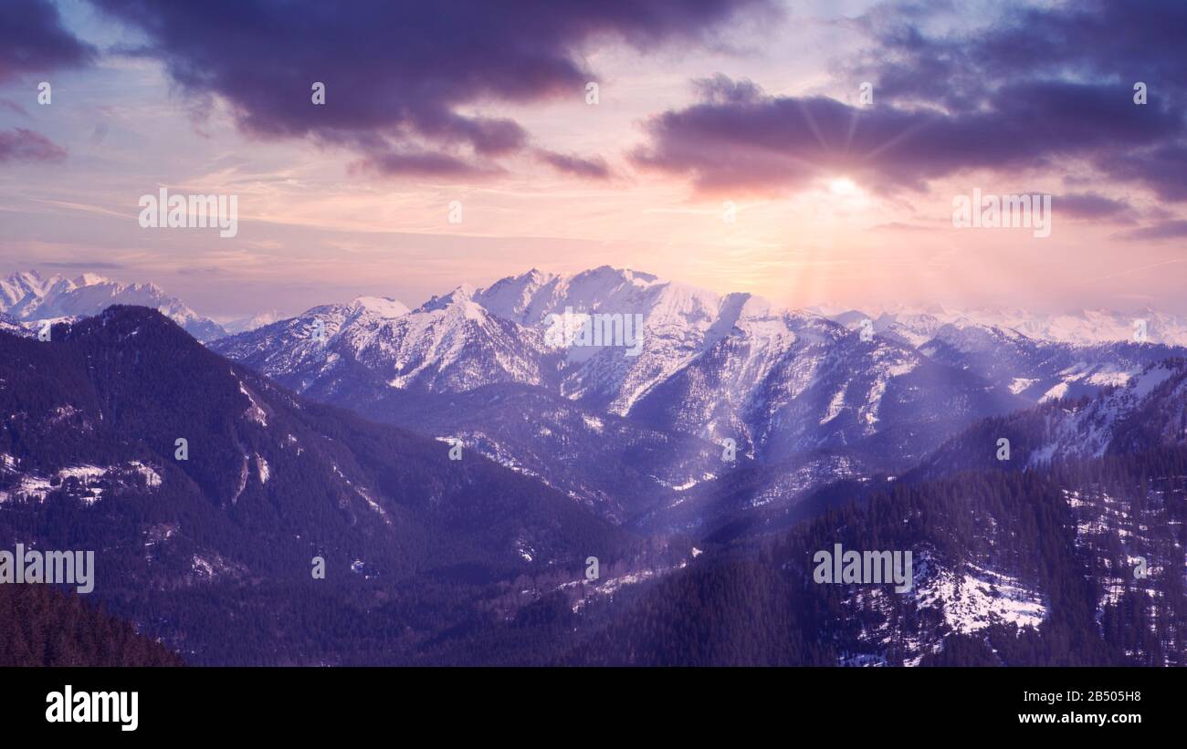 panoramic view of snowy mountains and rays of the sun Stock Photo - Alamy