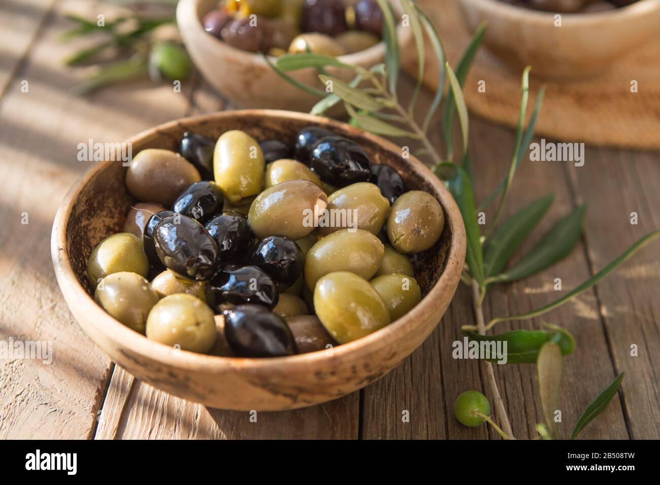 bowls with different kind of olives : green black kalamata olives with olive  oil Stock Photo - Alamy