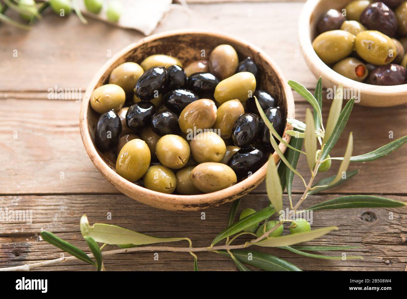 bowls with different kind of olives green olives, black olives, olives