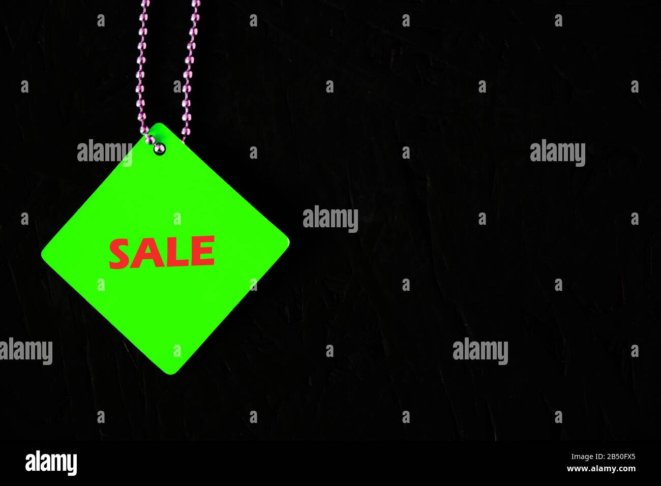 Green tag with the words sale on a black background Stock Photo Alamy