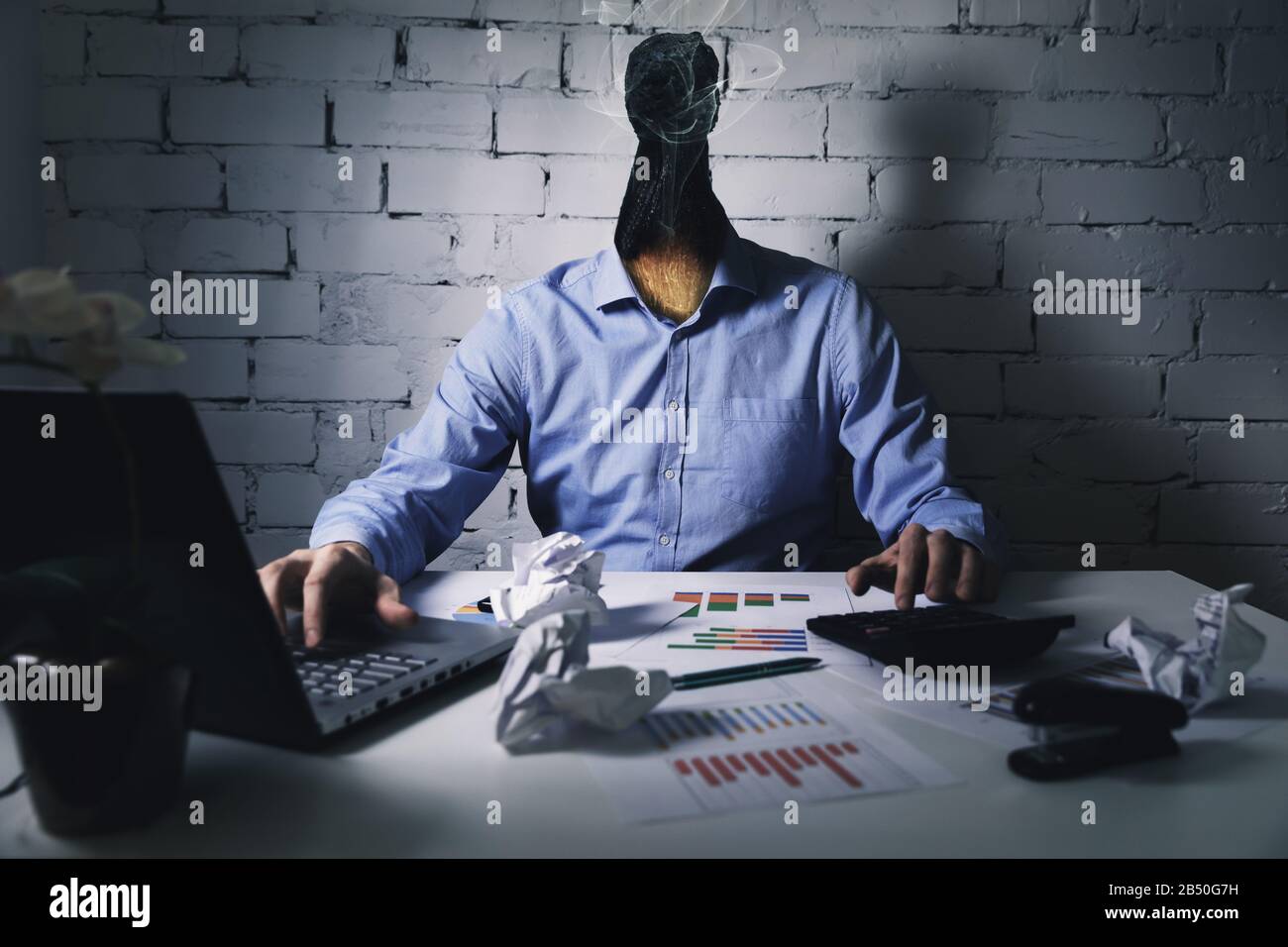 burnout syndrome at work concept. exhausted overworked man working in office Stock Photo