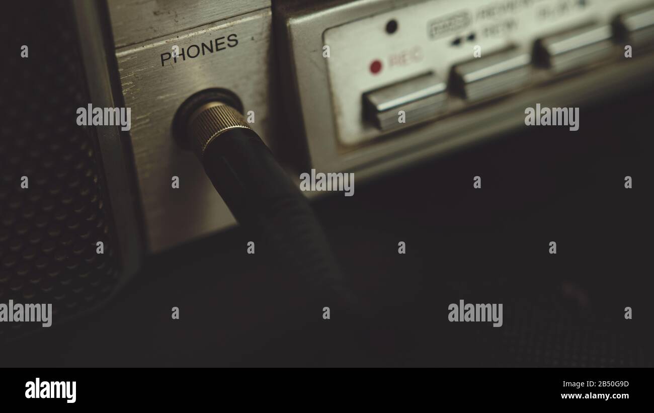 The old cassette player boombox headphone jack plugs into a headphone jack.  Retro music concept Stock Photo - Alamy
