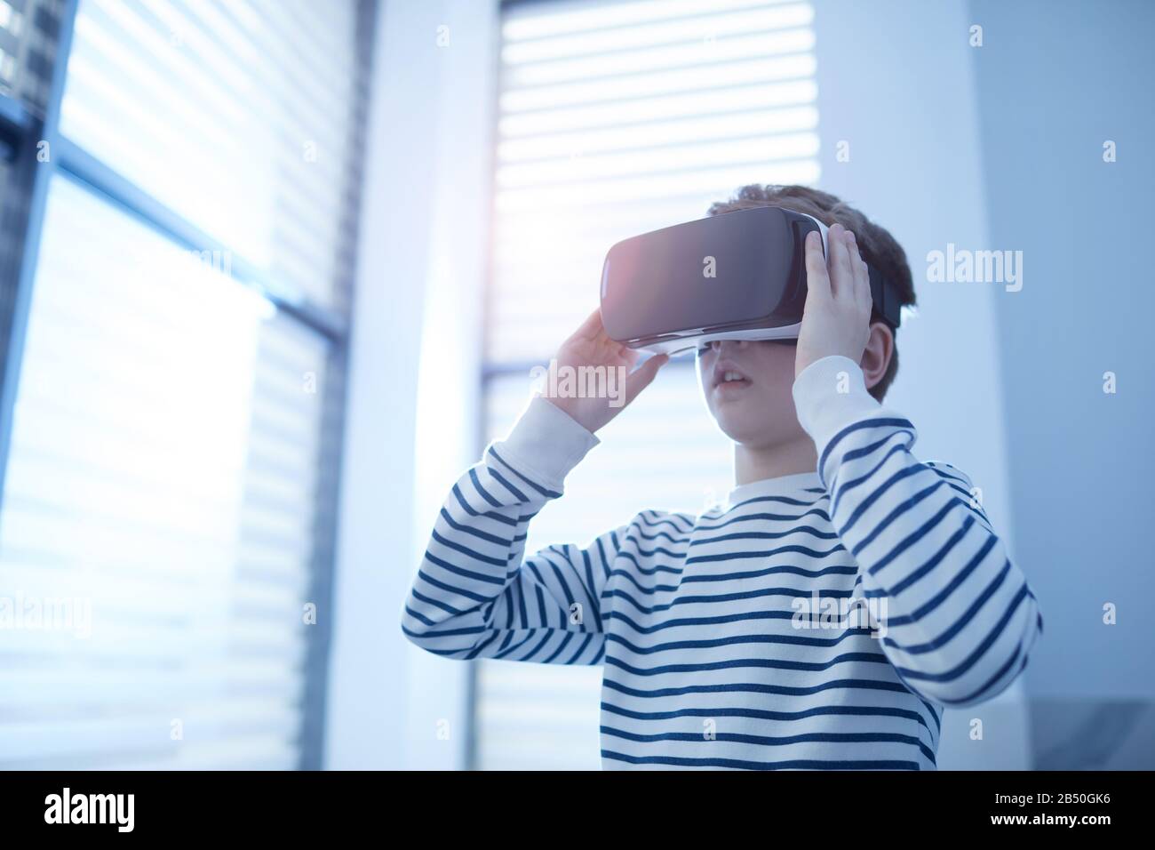 Horizontal medium low angle portrait of unrecognizable tenyearold