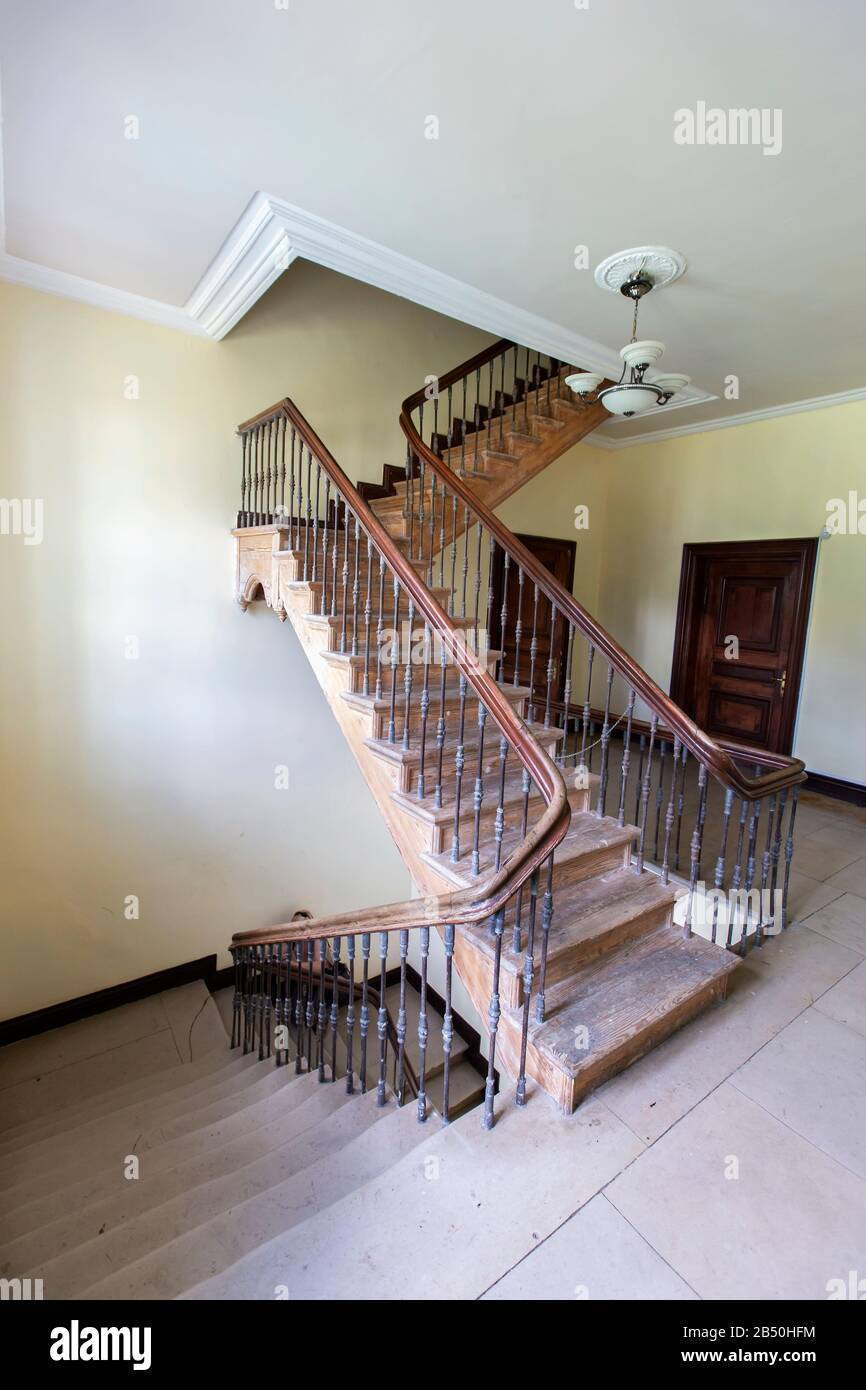 Ancient staircase with iron balusters and wooden railing Stock Photo ...