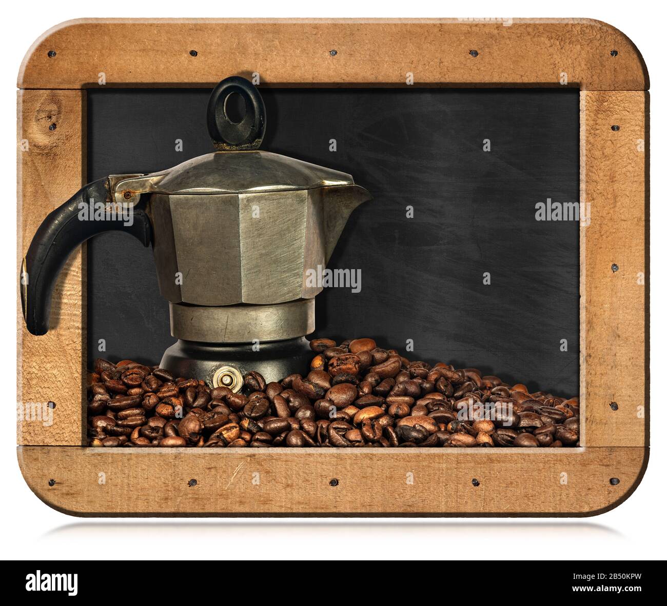 Old Italian coffee maker (moka pot, side view) on a stack of roasted coffee beans, in a blackboard with copy space, isolated on white background Stock Photo